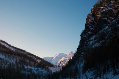 Scenic view of snowcapped mountains against clear sky