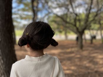 Rear view of young girl looking away