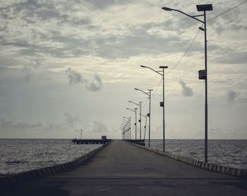 Street by sea against sky