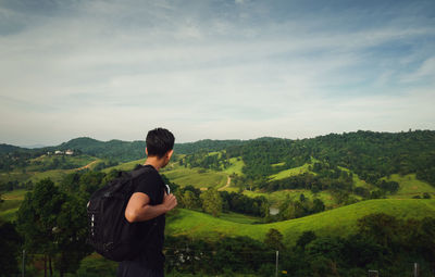 Rear view of man standing against mountain