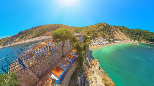 High angle view of sea against clear blue sky