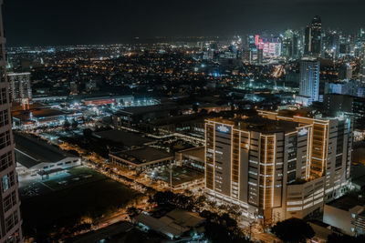 High angle view of illuminated buildings in city at night