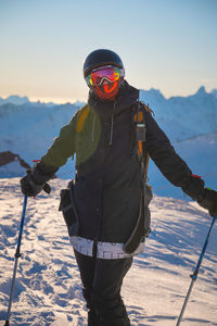 Winter skis. ski portrait of a woman skier. portrait of happy skier holding sticks and looking at