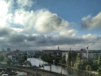 Cityscape against cloudy sky