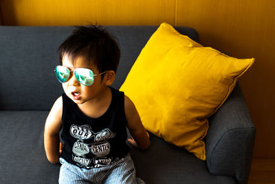 Full length of boy on sofa at home