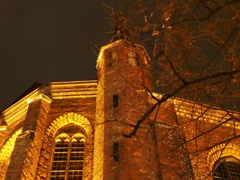 Low angle view of illuminated cathedral against sky at night