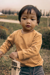 Portrait of cute boy standing outdoors