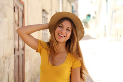 Portrait of smiling young woman in hat