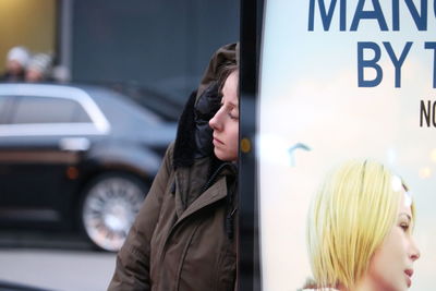 Close-up of woman standing by car