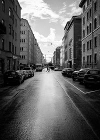 Vehicles on road along buildings