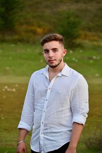 Portrait of young man standing outdoors