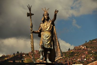 Low angle view of statue against cloudy sky