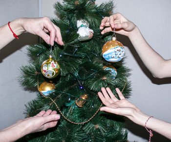 Cropped hands of woman holding christmas decoration