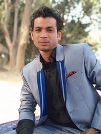 Portrait of young man sitting outdoors