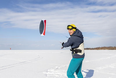 Rear view of man standing on snow