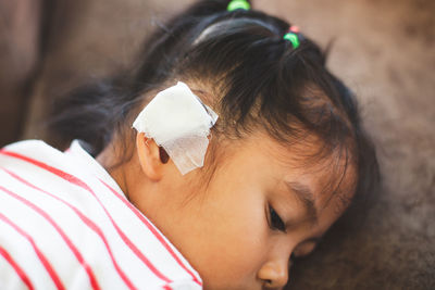 Close-up of girl with bandage on ear