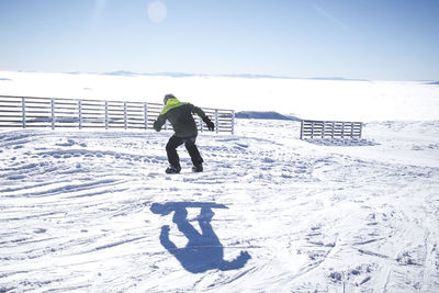 Full length of man on snowboard