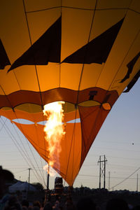 Low angle view of hot air balloon against orange sky