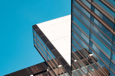 Low angle view of modern building against clear blue sky