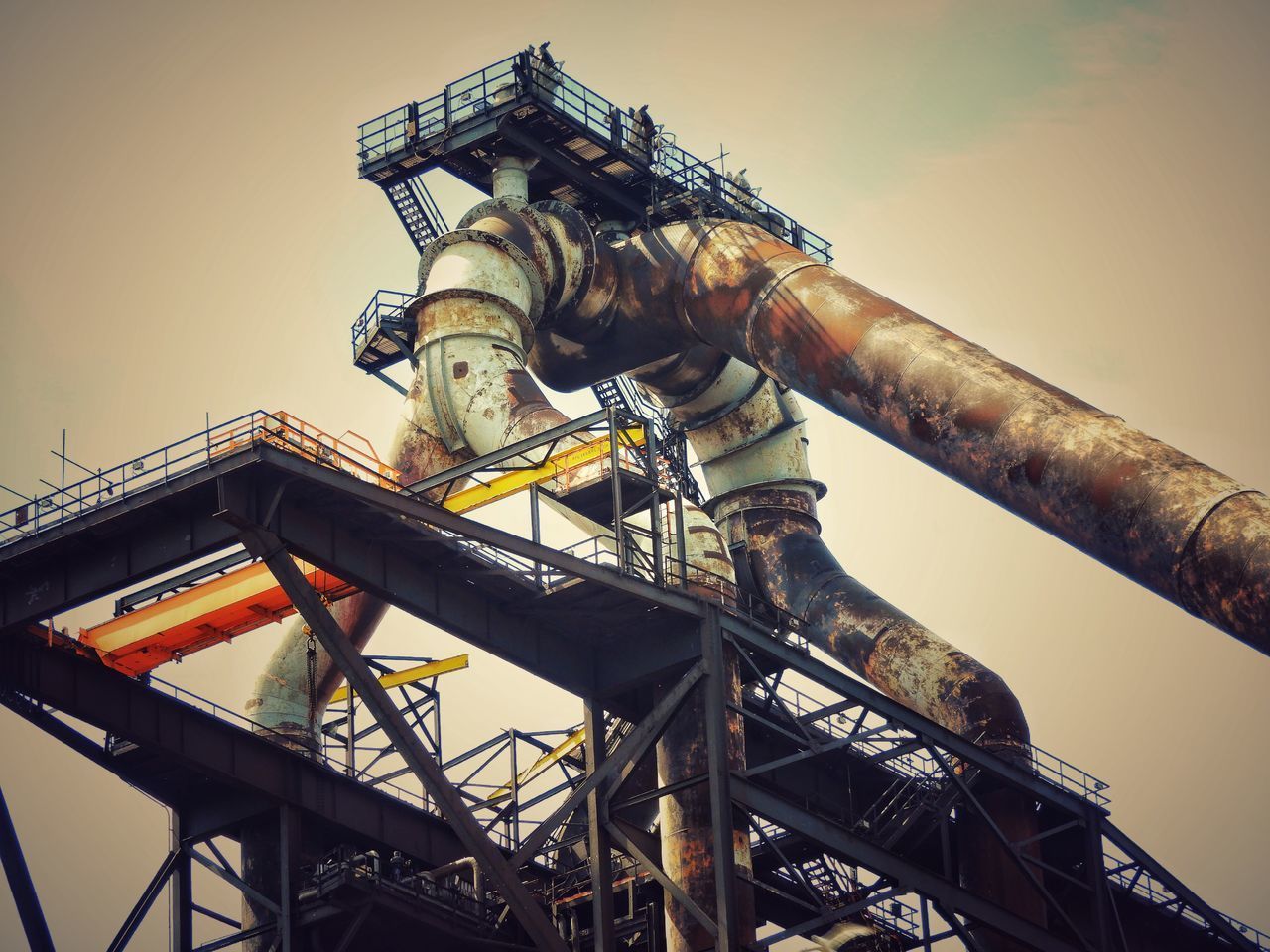 LOW ANGLE VIEW OF METALLIC STRUCTURE AGAINST SKY