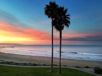 Scenic view of calm beach against blue sky