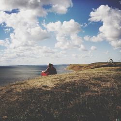 Scenic view of sea against cloudy sky