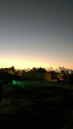 Buildings against sky at sunset