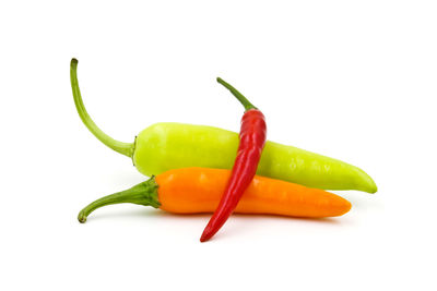 Close-up of chili peppers against white background