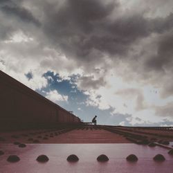 Low angle view of built structure against cloudy sky