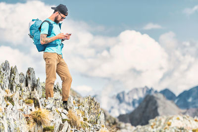 Low angle view of woman standing on rock