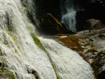 Scenic view of stream flowing through rocks