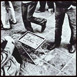 Low section of man standing on tiled floor