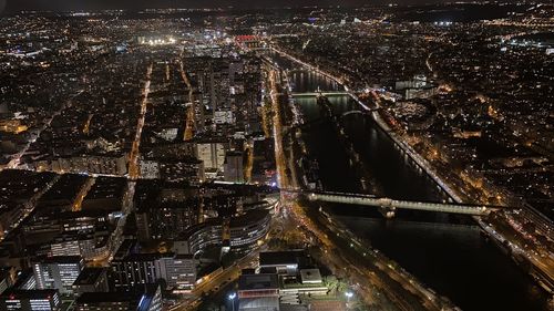 High angle view of illuminated street amidst buildings at night