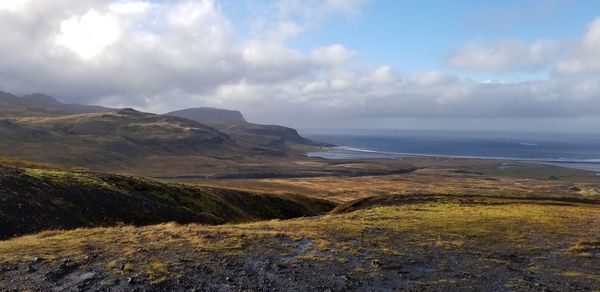 Scenic view of sea and mountains against sky