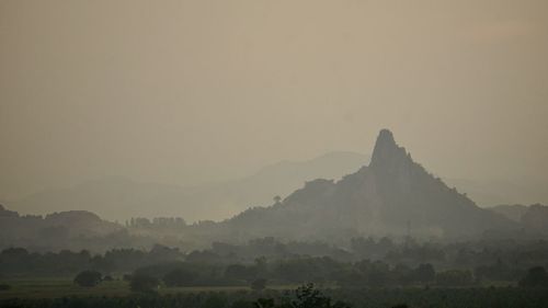 Scenic view of mountain against sky during foggy weather