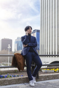 Low angle view of young man standing on street