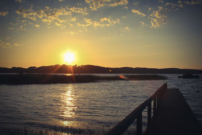 Scenic view of river at sunset