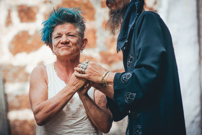 Man holding woman standing against blurred background