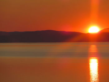 Scenic view of sea against orange sky