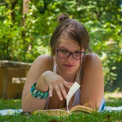 Portrait of young woman sitting on grass