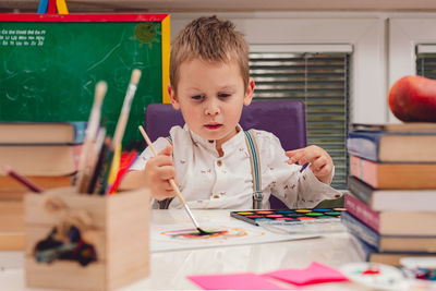 Child painting with watercolors