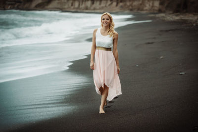 Full length portrait of woman at beach