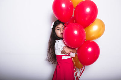Rear view of girl holding balloons