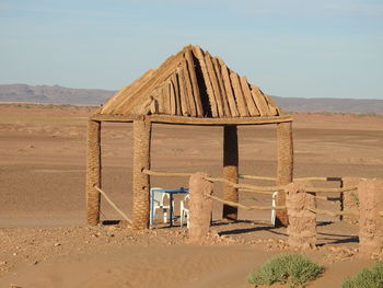 Abandoned built structure on desert against sky