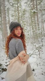 Young woman wearing hat in forest
