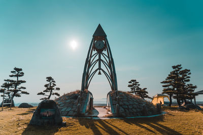 Traditional windmill on field against clear sky