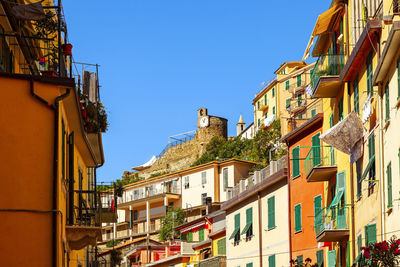 Low angle view of buildings against blue sky