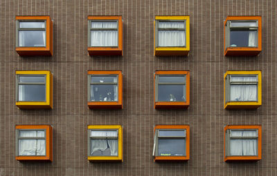 Low angle view of yellow windows on building