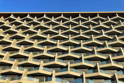 Full frame shot of modern building against clear blue sky