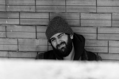 High angle view of man wearing knit hat against wall